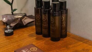 A wooden tray with several black bottles labeled "OUR MINAS" and a small brown box with the same logo.