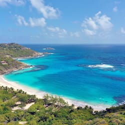On the beach, white sand, sun loungers, beach umbrellas
