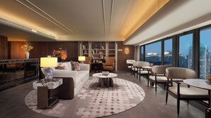 A modern hotel lobby with a sofa, chairs, a coffee table, and a city view. - The Kunlun Hua Ting Hotel & Towers,Shanghai (Shanghai)
