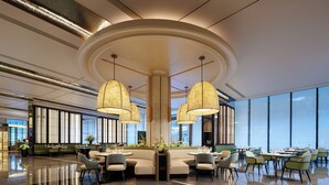 A modern hotel lobby with a central seating area, large windows, and a polished floor. - The Kunlun Hua Ting Hotel & Towers,Shanghai (Shanghai)