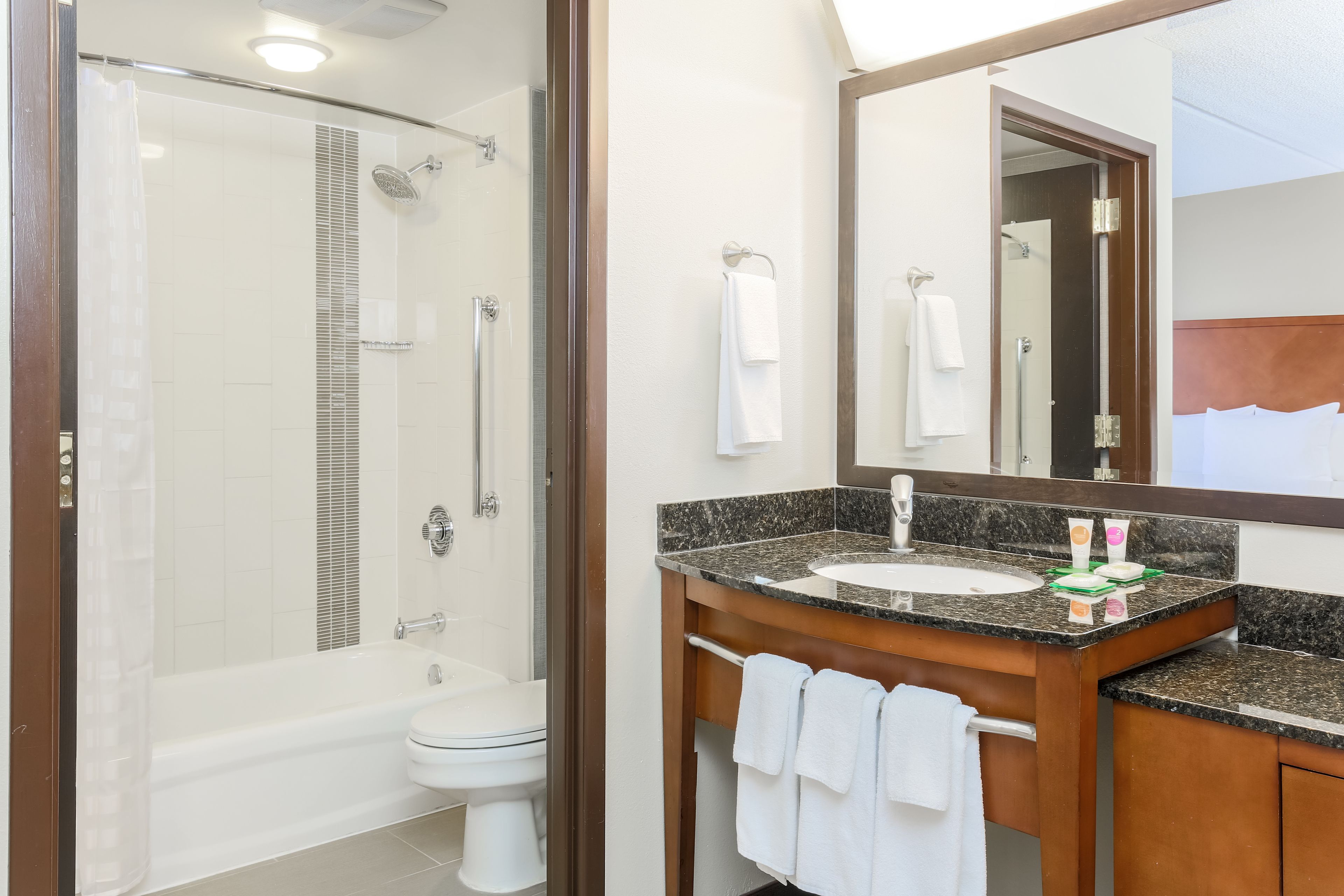 combined shower/bathtub, designer toiletries, hair dryer, towels