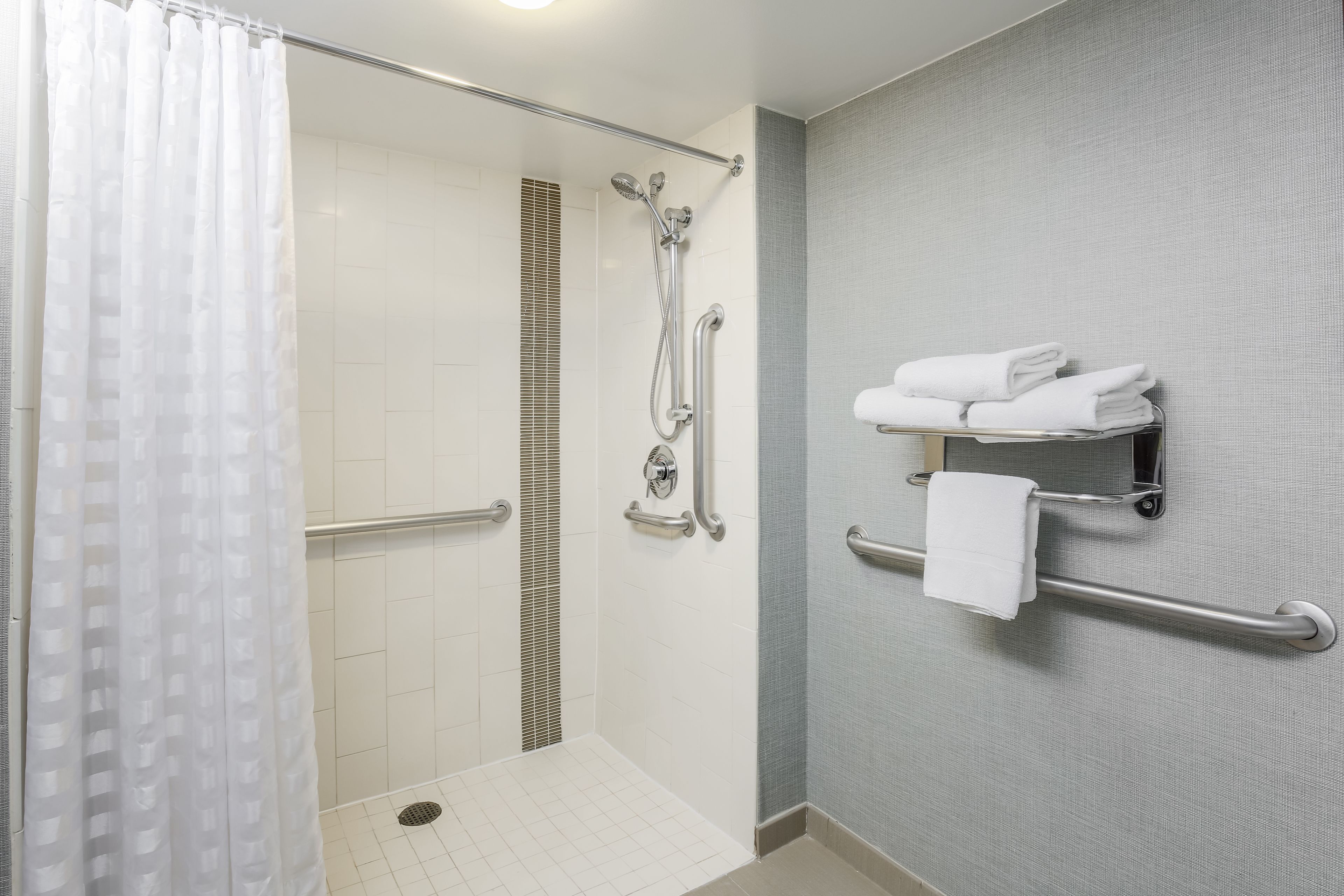 combined shower/bathtub, designer toiletries, hair dryer, towels