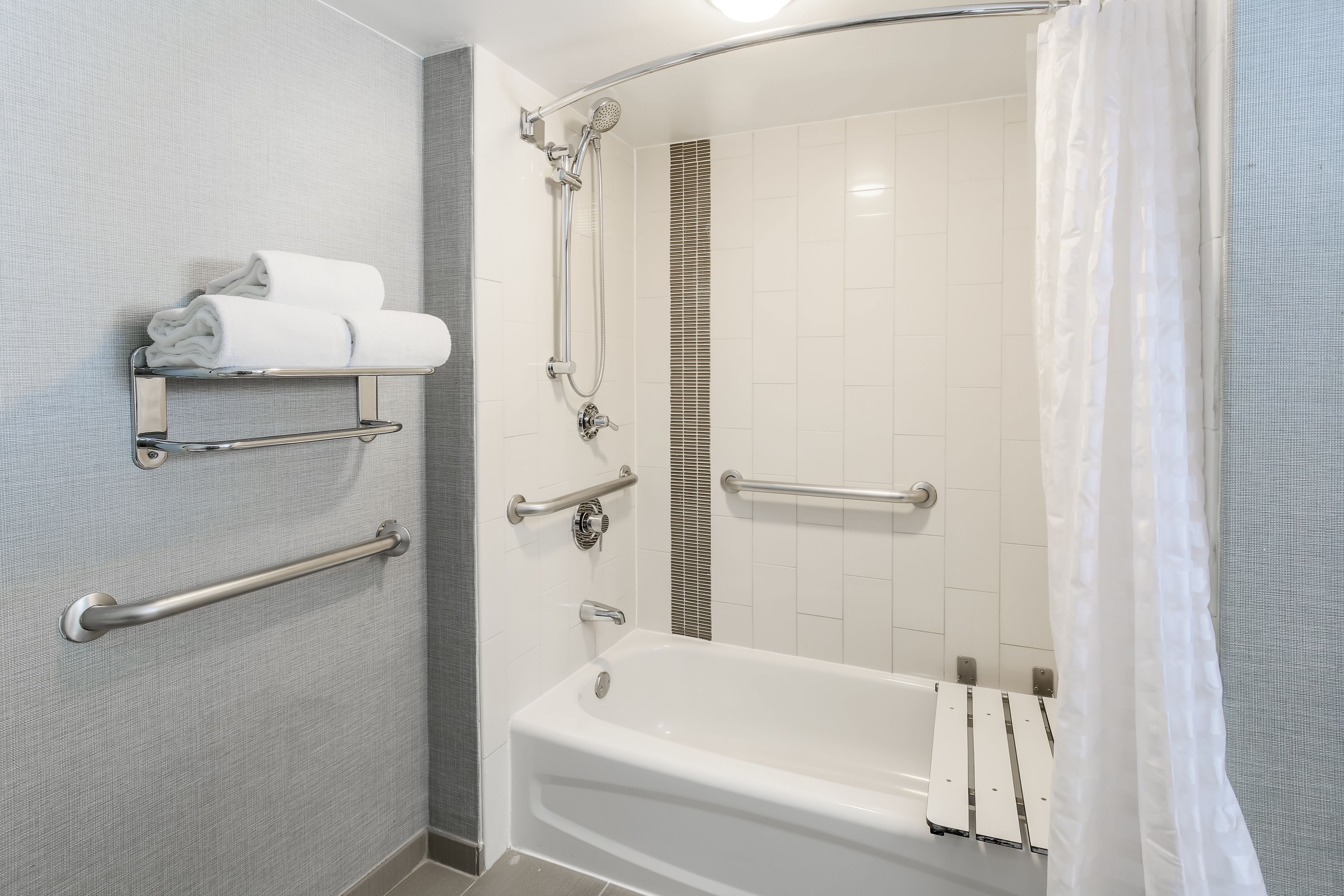 combined shower/bathtub, designer toiletries, hair dryer, towels