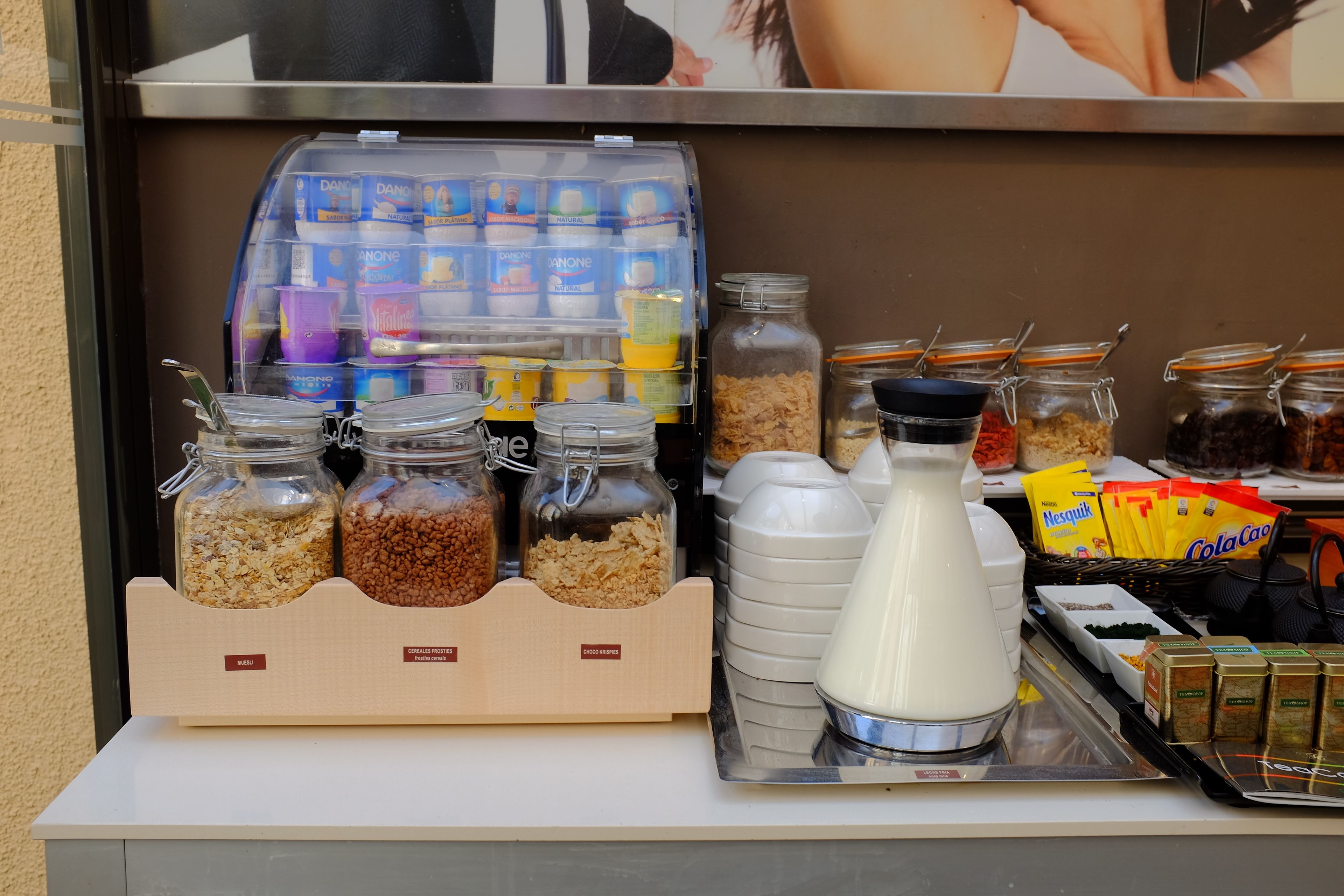 A breakfast bar with various food items and beverages.