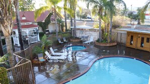 A swimming pool with lounge chairs and a gazebo. - Dynasty Suites Redlands (Redlands)
