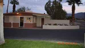 A small, single-story building with a flat roof and a front entrance.