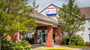 A brick building with a sign for Ameriway Inn and Suites.