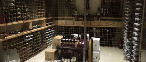 A wine cellar with numerous wine racks and boxes.
