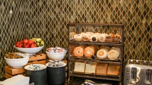 A breakfast buffet with various food items and a toaster. - Country Inn & Suites by Radisson, Washington Dulles International Airport, VA (Sterling)