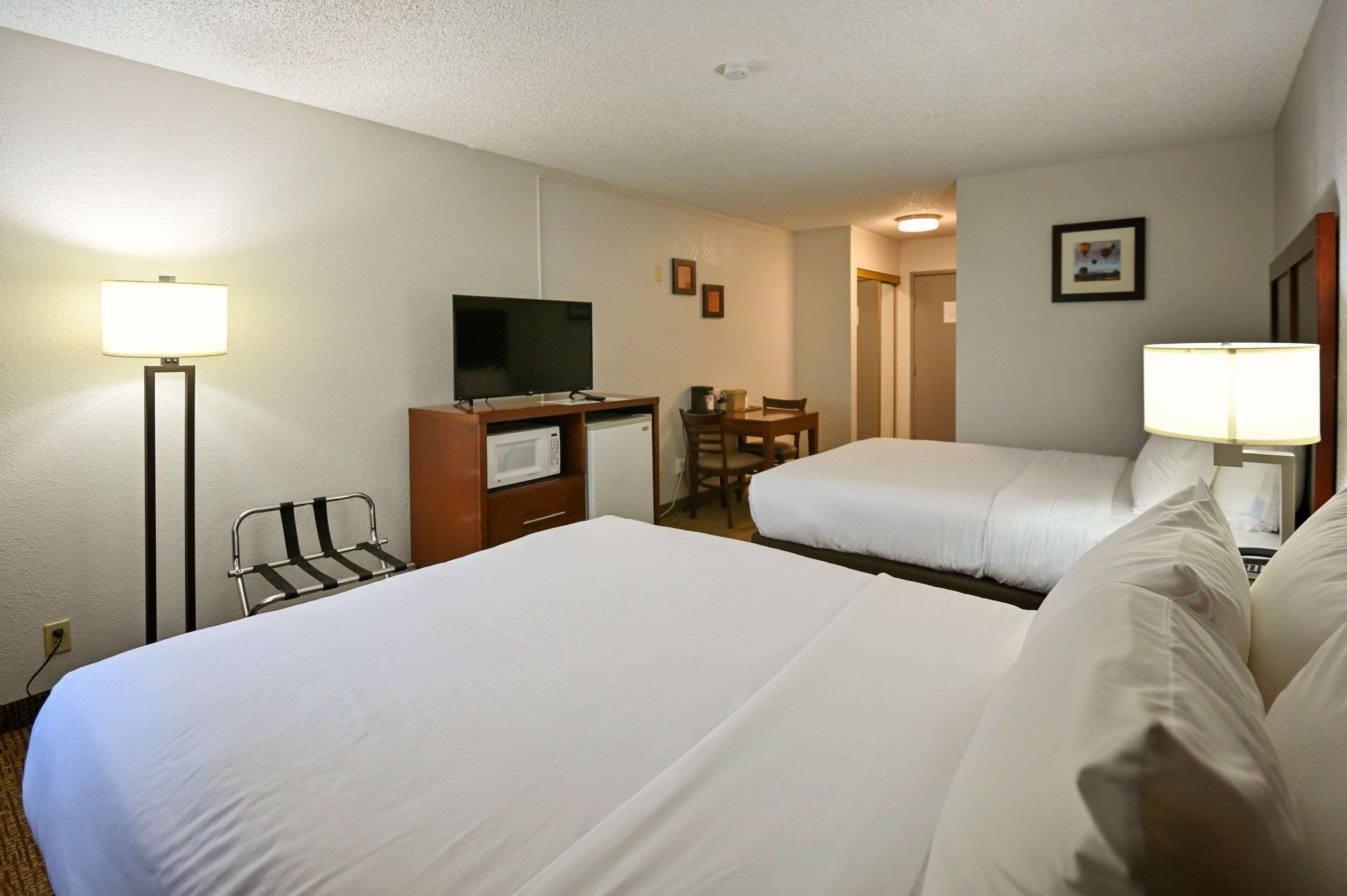 Premium bedding, desk, laptop workspace, blackout drapes