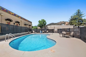 Seasonal outdoor pool, open 10:00 AM to 9:00 PM, pool loungers