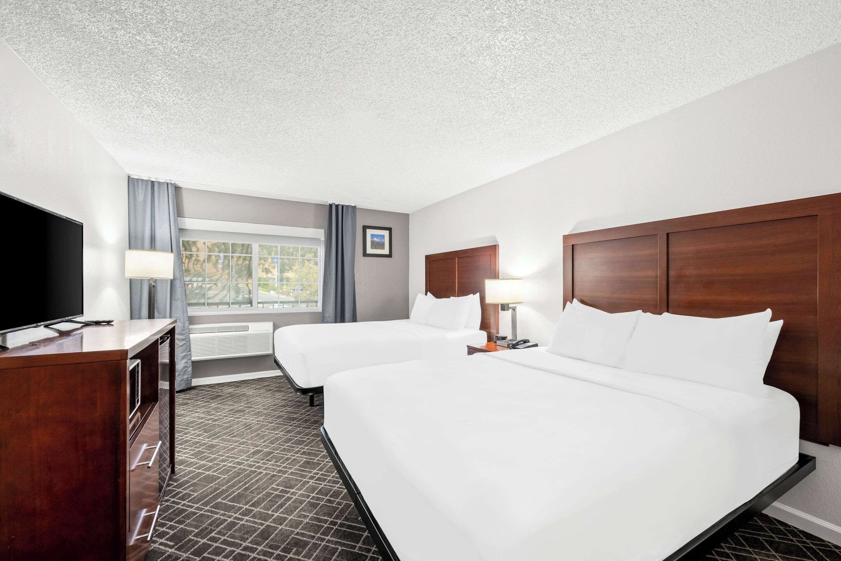 Premium bedding, desk, laptop workspace, blackout drapes