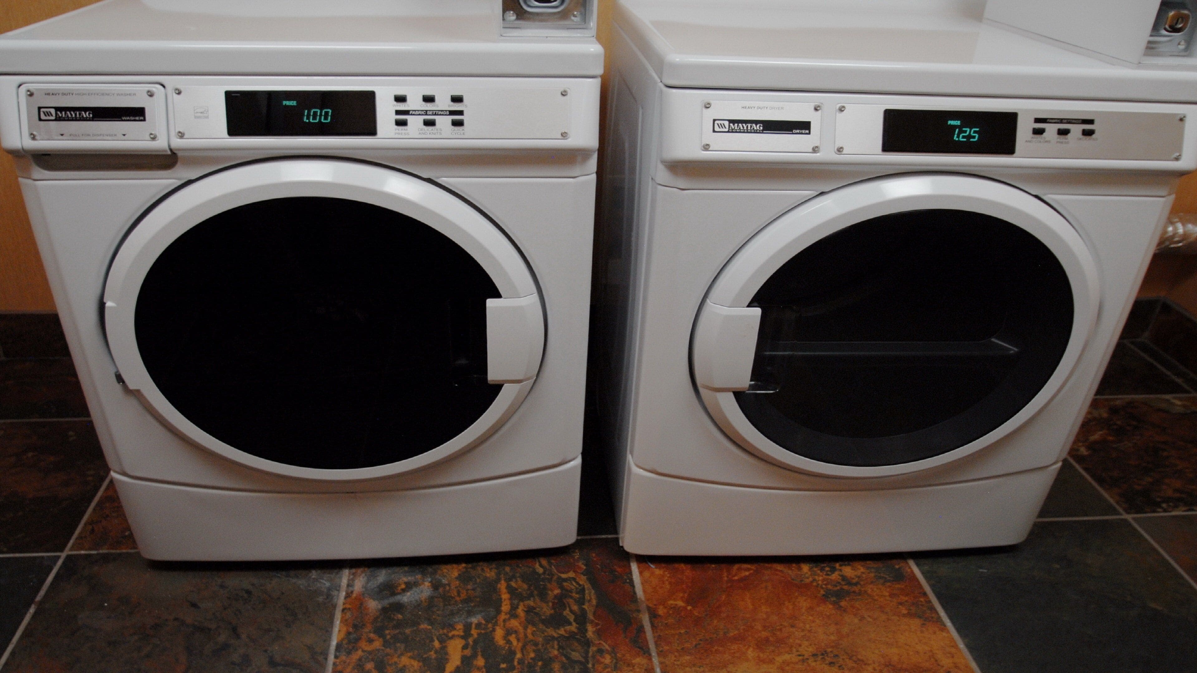Two front-loading washing machines with digital displays and control panels.