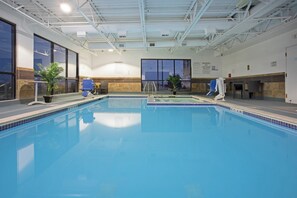 An indoor swimming pool with clear water, a lifeguard chair, and a pool rule sign. - Holiday Inn Express & Suites Denver SW-Littleton by IHG (Littleton)