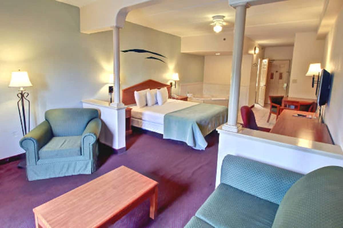 Suite, 1 King Bed, Jetted Tub | In-room safe, desk, iron/ironing board, cots/infant beds