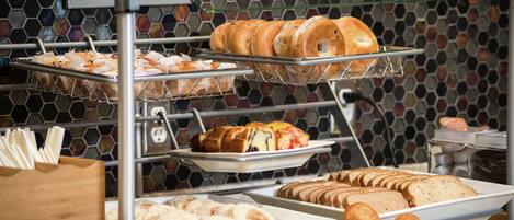 A breakfast buffet with various pastries and breads.