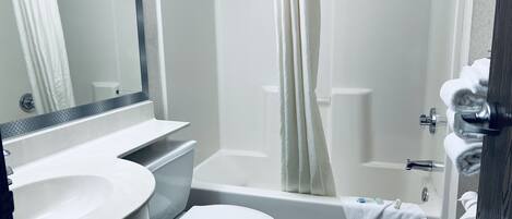 A bathroom with a sink, toilet, and bathtub.