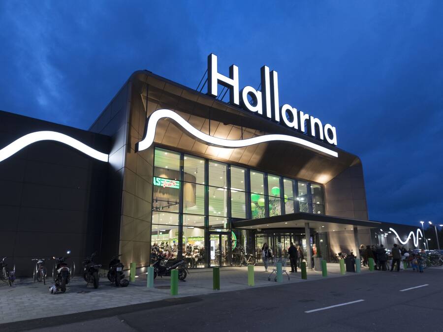 A modern building with the name "Hallarna" prominently displayed.