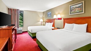A hotel room with two beds, a TV, a desk, and a window with curtains. - Econo Lodge Mt Hope - Beckley North (Mount Hope)