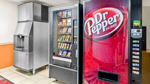 A Dr Pepper vending machine and a water dispenser in a commercial setting. - Econo Lodge Mt Hope - Beckley North (Mount Hope)