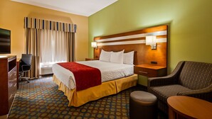 A hotel room with a bed, a desk, a chair, and a small table. - Best Western Troy Hotel (Troy)