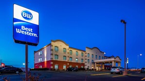 A Best Western hotel with a large sign, multiple parking spaces, and a well-lit entrance. - Best Western Troy Hotel (Troy)
