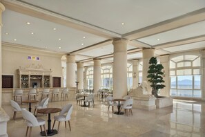 A spacious lobby with high ceilings, large columns, and a bar area. - Sheraton Sharm Hotel, Resort, Villas & Spa (Sharm El Sheikh)