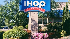 A blue IHOP restaurant sign with a red banner stating "IHOP RESTAURANT". - Sleep Inn - SeaTac Airport (SeaTac)