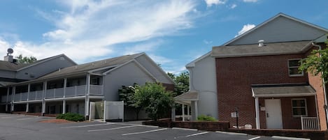 A row of two-story buildings with a parking lot in front.