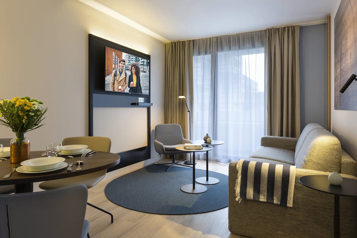 Deluxe Apartment, 1 Bedroom, Balcony | Living room | Flat-screen TV