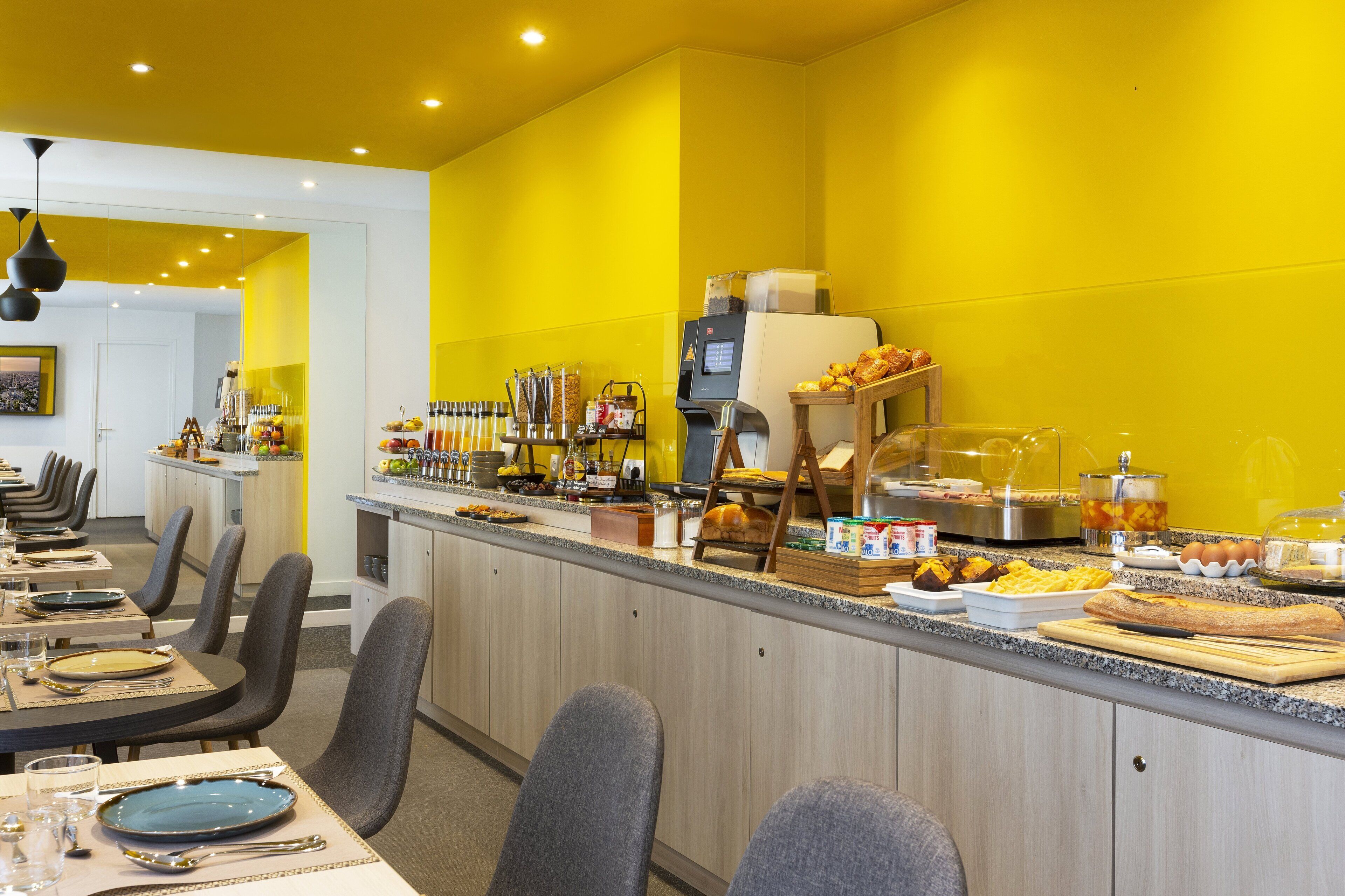 A breakfast bar with seating and a coffee station.