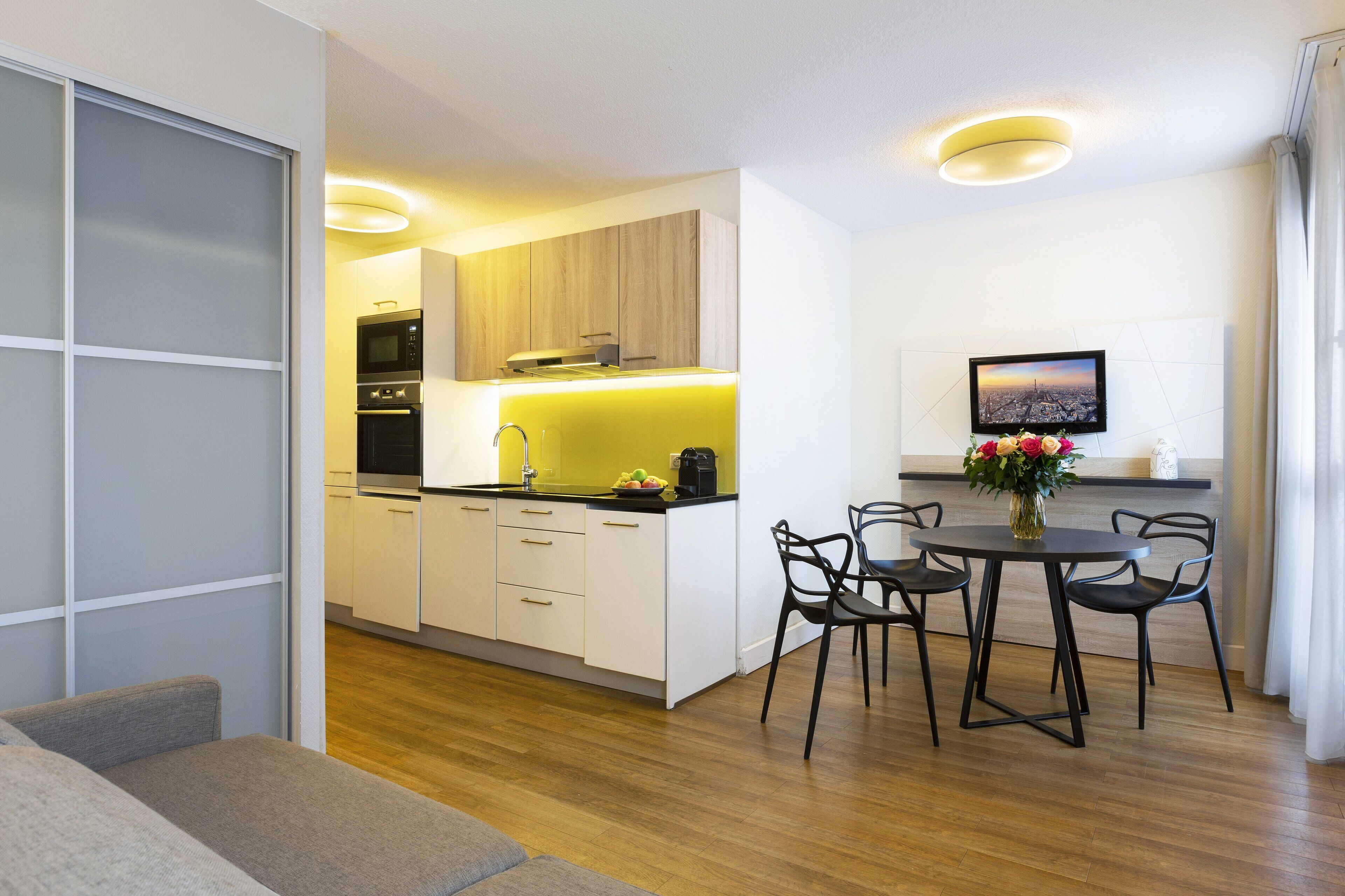 1-Bedroom Eiffel Tower View | Living room | Flat-screen TV