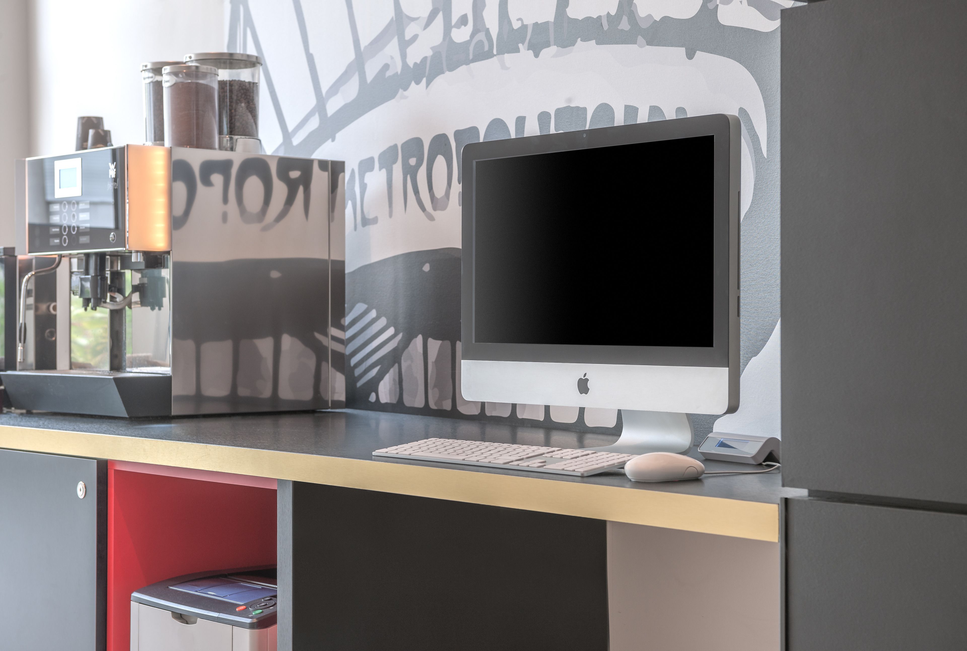 A modern office desk with a computer, keyboard, and mouse.