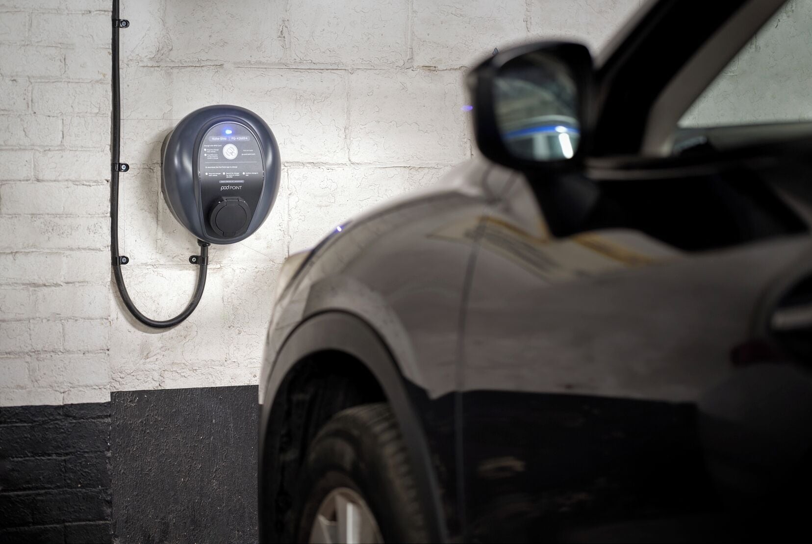 A parking garage with a car charging station.