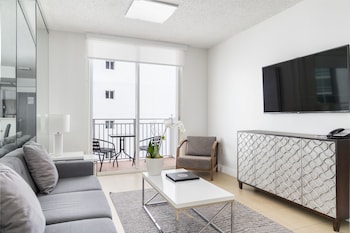 Standard One bedroom Suite with Balcony | Living area | 42-inch TV with cable channels at Fortune House Hotel Suites