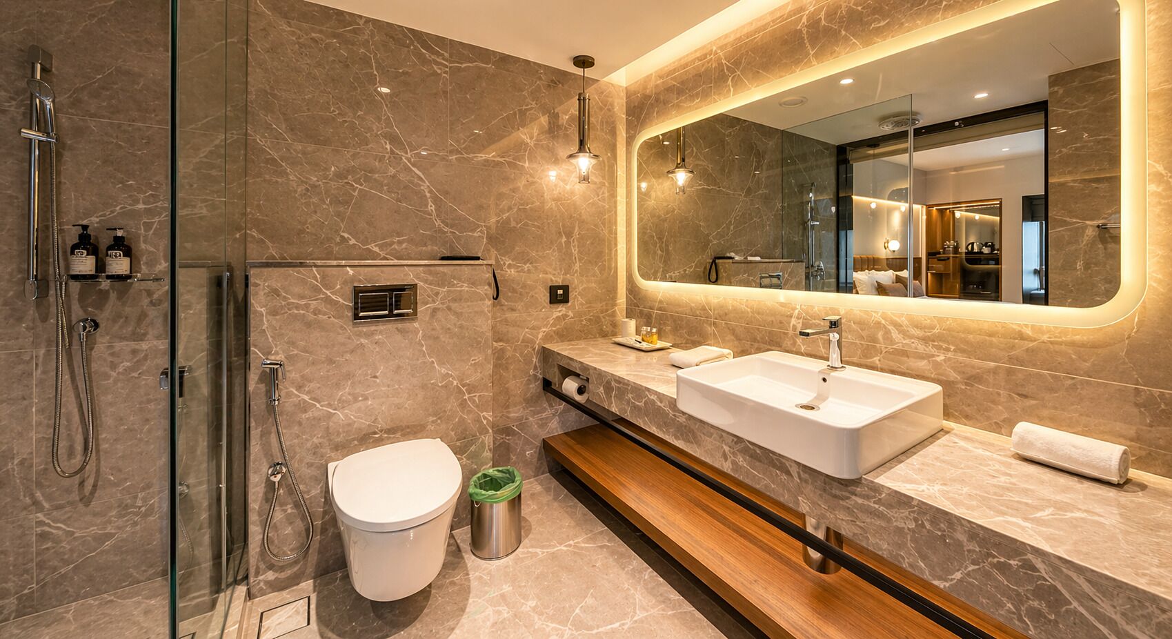 A modern bathroom with a glass-enclosed shower, a white toilet, a vanity with a large mirror, and a sink.