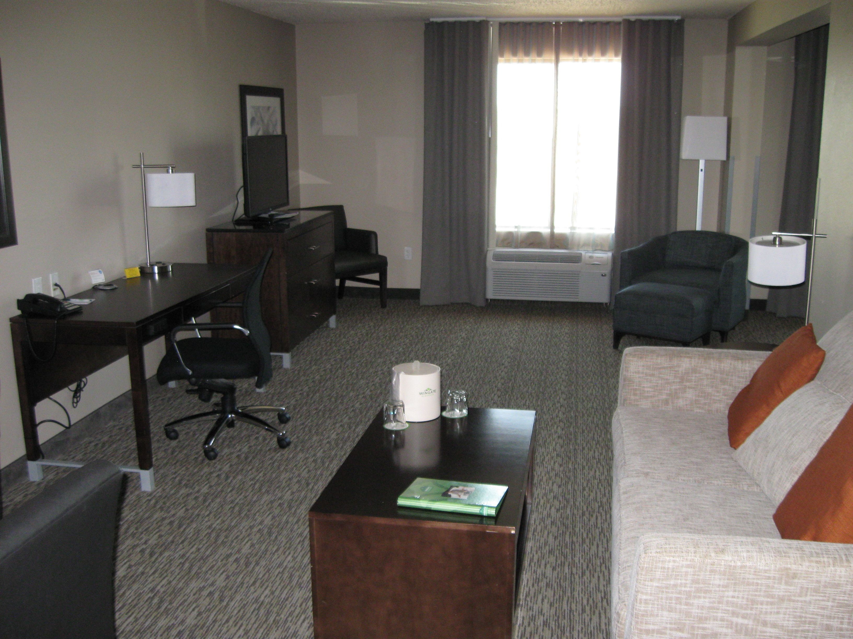 suite, 1 king bed, hot tub | living area | flat-screen tv