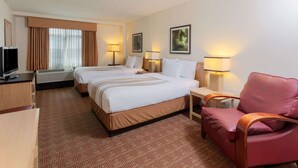 A hotel room with two beds, a TV, a desk, and a chair. - La Quinta Inn & Suites by Wyndham Garden City (Garden City)