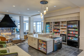 A spacious kitchen with a central island, built-in refrigerators, and a variety of food items.