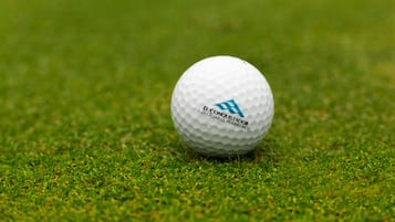 A golf ball on a grassy surface.