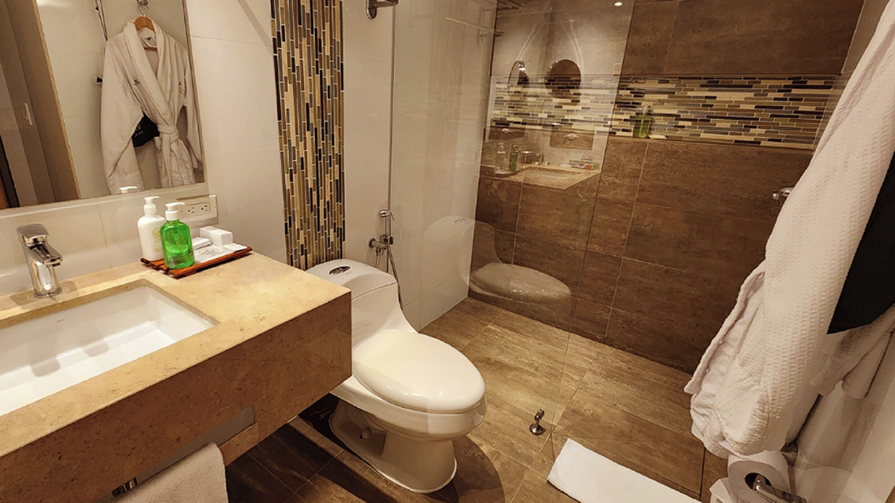 A modern bathroom with a sink, toilet, and shower.