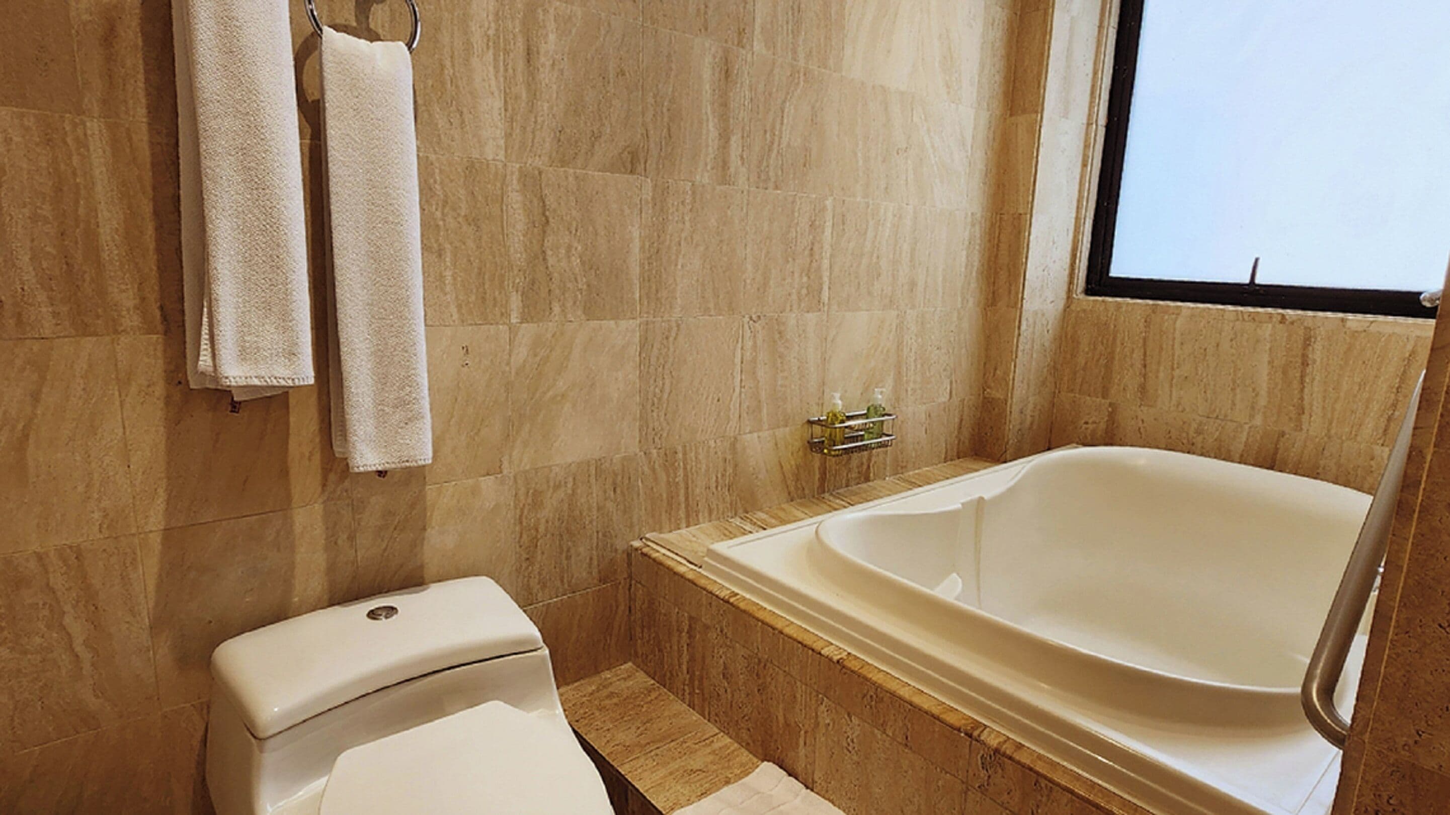 business suite, 1 king bed with sofa bed | bathroom | free toiletries, hair dryer, slippers, towels