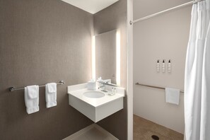 A modern bathroom with a white sink, mirror, and towel rack. - SpringHill Suites by Marriott Pasadena Arcadia (Arcadia)