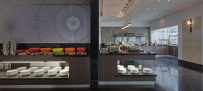 A modern kitchen with a central island, stainless steel appliances, and a decorative backsplash. - Swissotel Sydney (Sydney)