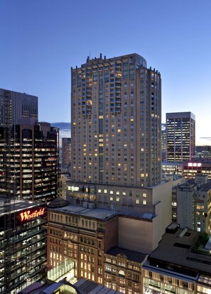 A high-rise building with multiple floors, large windows, and a prominent Westfield sign.