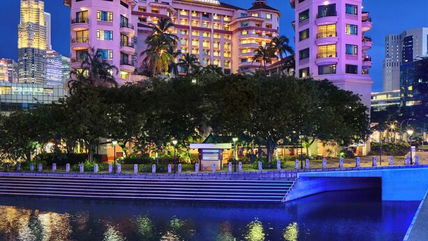 A multi-story hotel with balconies and a pool area in front. - Paradox Singapore (Singapore)
