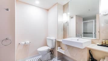Une salle de bain moderne équipée de toilettes, d’un lavabo et d’une zone douche.