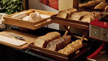 Une vitrine de boulangerie présentant différents types de pain et de viennoiseries.