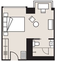 A hotel room layout with a bed, desk, chair, and a small bathroom area.