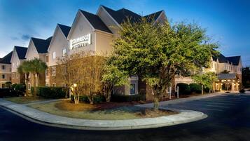 A Staybridge Suites hotel with a modern architectural design, featuring a prominent entrance and a well-maintained landscaped area.